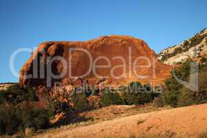 Red rock cliff resembling car