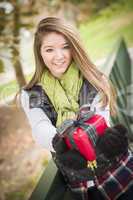 Pretty Woman with Wrapped Gift with Bow Outside