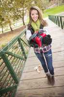 Pretty Woman with Wrapped Gift with Bow Outside