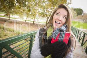 Pretty Woman with Wrapped Gift with Bow Outside