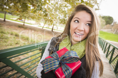 Pretty Woman with Wrapped Gift with Bow Outside