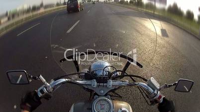 Biker driving the motorcycle on city highway, POV
