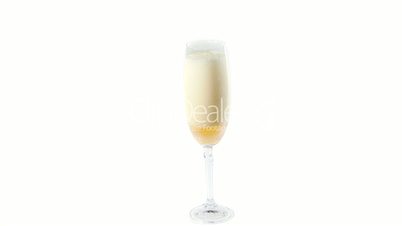 Cider flowing into the glass with bubbles isolated on white