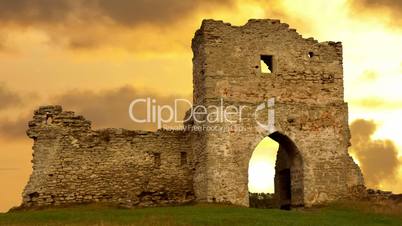 Ruined gates of cossack castle at sunset