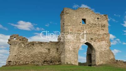 Ruined gates of cossack castle with blue sky and clouds