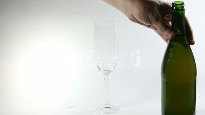 Cider flowing into the glass with bubbles isolated on white