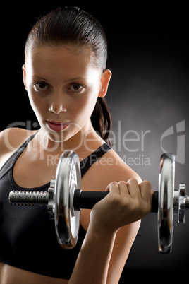 Active woman exercise weights on black background