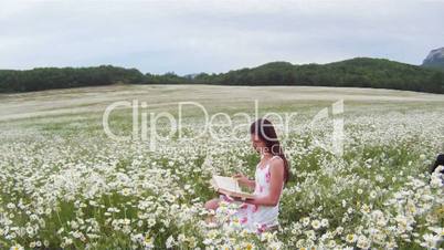 Reading a book in a field