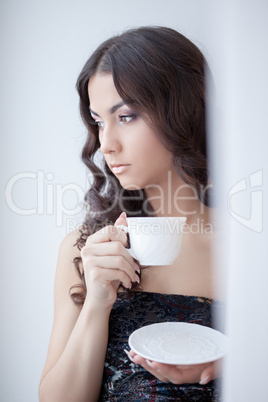 Pretty brunette woman drinking coffee