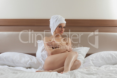 Sexy and pretty woman in towel on bed