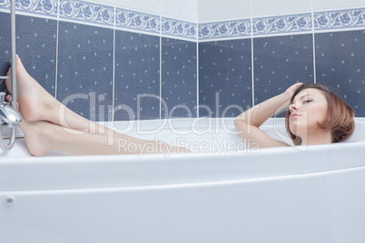 Pretty woman lying in bath