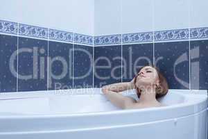 Brunette woman lying in bath