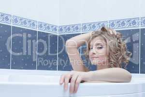 Young blonde woman in bath