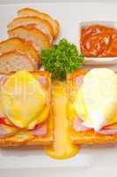 eggs benedict on bread with tomato and ham