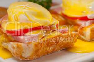 eggs benedict on bread with tomato and ham