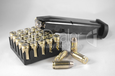 Handgun clip and bullets isolated on white
