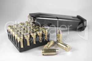 Handgun clip and bullets isolated on white