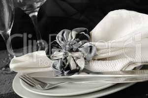 decorative folded napkin on a plate with cutlery