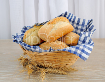 fresh bread in a basket with a napkin shelter