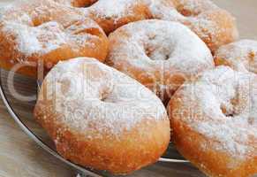 fried donuts in powdered sugar closeup