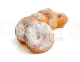 fried donuts in powdered sugar on a white background