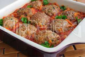 meatballs with herbs and tomato sauce in the pan
