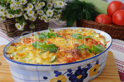 casserole of pasta with zucchini and tomato with cheese