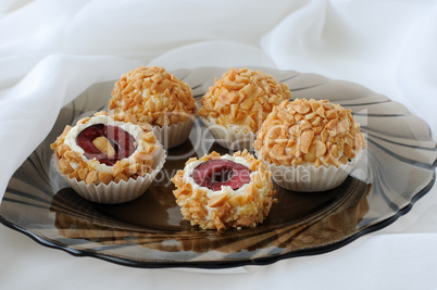 Cheese balls with cherries in peanuts