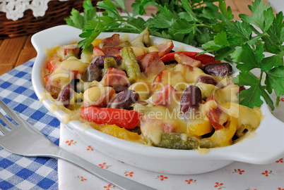 Beans with ham and vegetables, baked with cheese