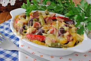 Beans with ham and vegetables, baked with cheese