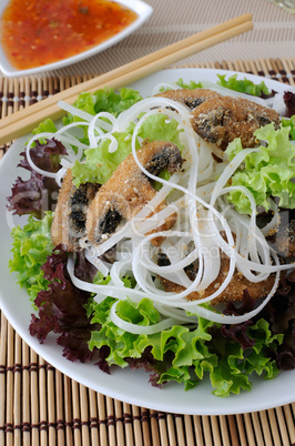 Rice noodles with mushrooms in breadcrumbs in lettuce leaves