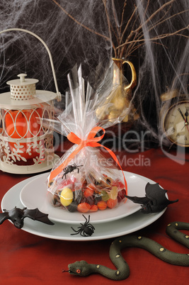 Sweets in the package on the festive table in honor of Halloween