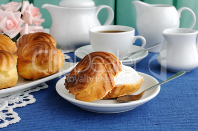 Eclairs with a cup of coffee