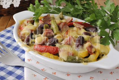 Beans with ham and vegetables, baked with cheese