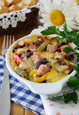 Beans with ham and vegetables, baked with cheese