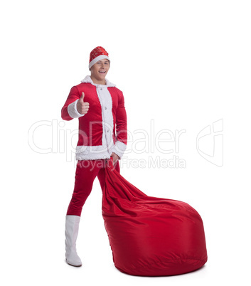 Happy young santa claus with huge red bag