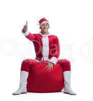 Young man santa claus sit on red bag with presents