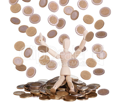 wooden doll sitting in rain of coins