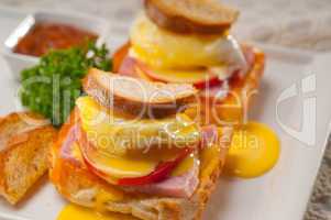 eggs benedict on bread with tomato and ham