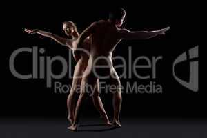Nude couple of man and woman dance in dark