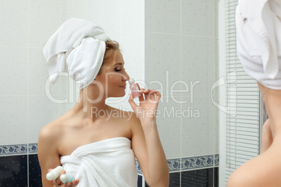 Beauty woman in bathroom smell perfume