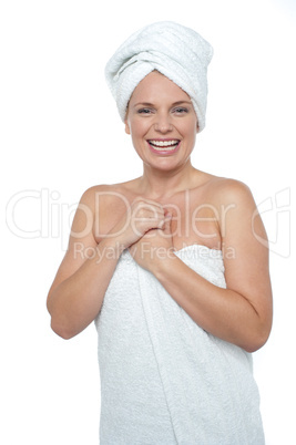 Blonde woman in towel smiling heartily