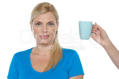 Woman is being offered a cup of beverage