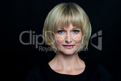 Blonde woman isolated against black background