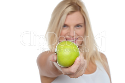 Glamorous blonde offering you juicy green apple