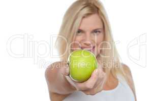 Glamorous blonde offering you juicy green apple