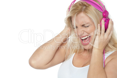 Blonde screaming while listening to rock music