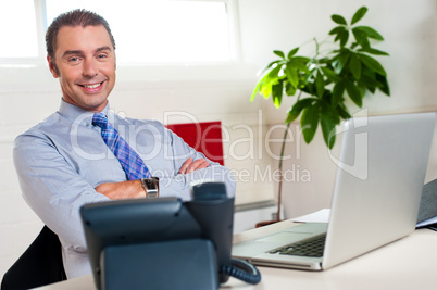 Confident businessman at his workstation