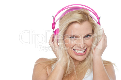 Hot blonde listening to music via headphones