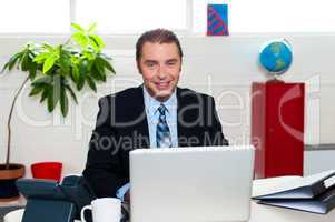 Corporate leader sitting in front of his laptop